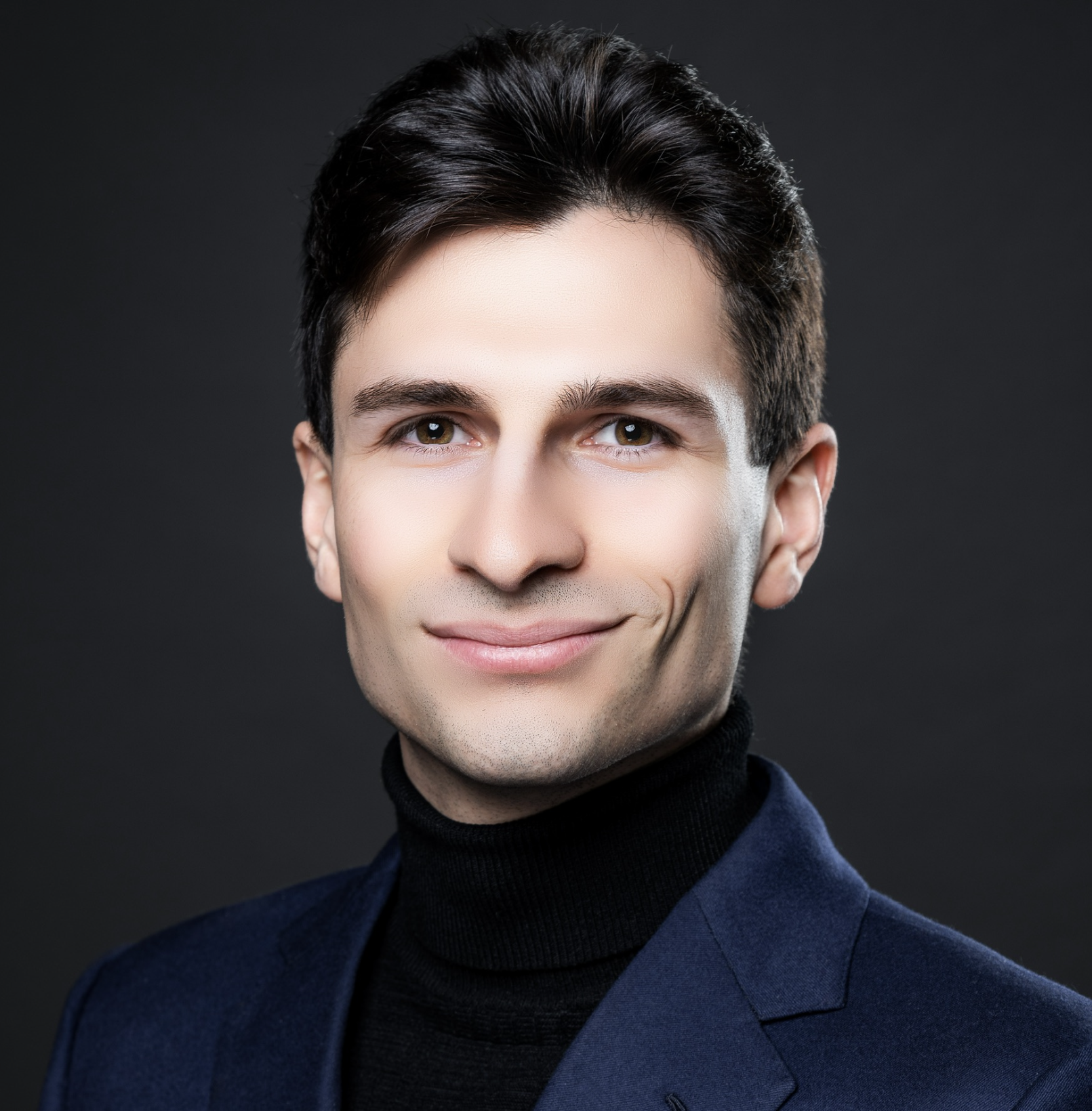 Professional headshot of Michele in a navy suit.